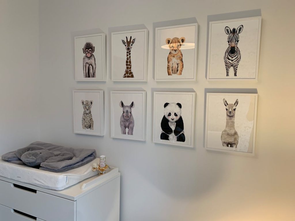 Adorable animal prints adding charm to a minimalist nursery wall decor.